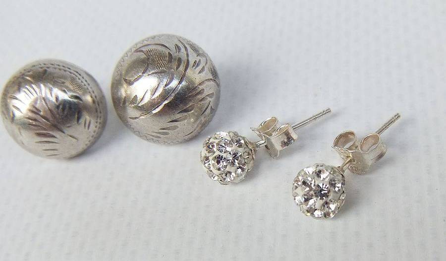 A pair of sterling silver dome earrings and sterling silver studs with faceted insets