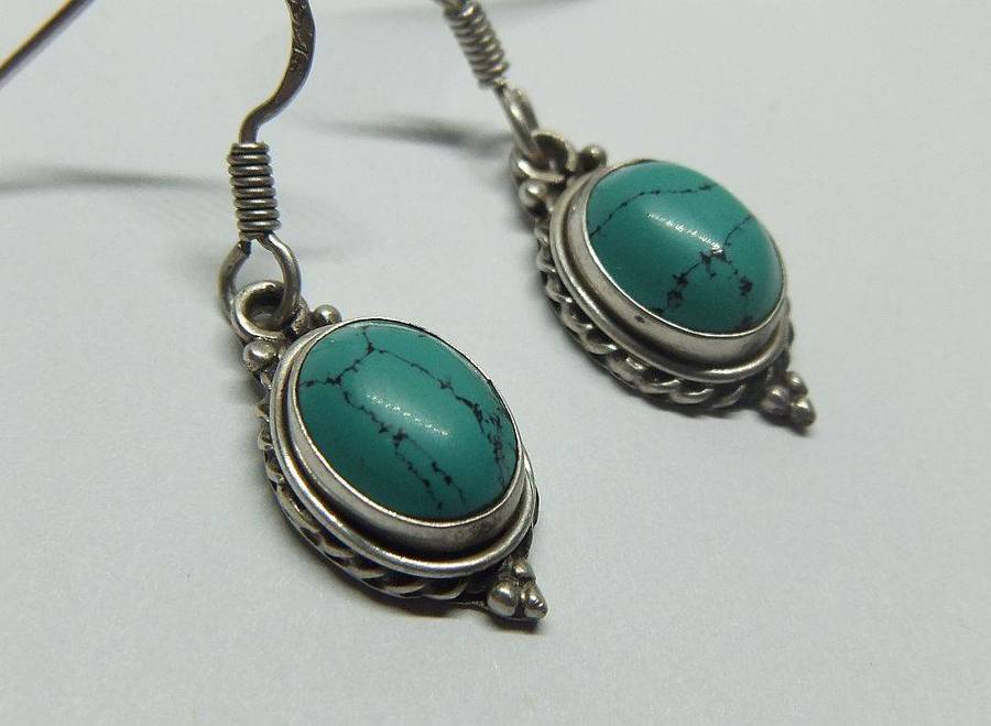A pair of vintage sterling silver earrings set with cabochon Turquoise stones