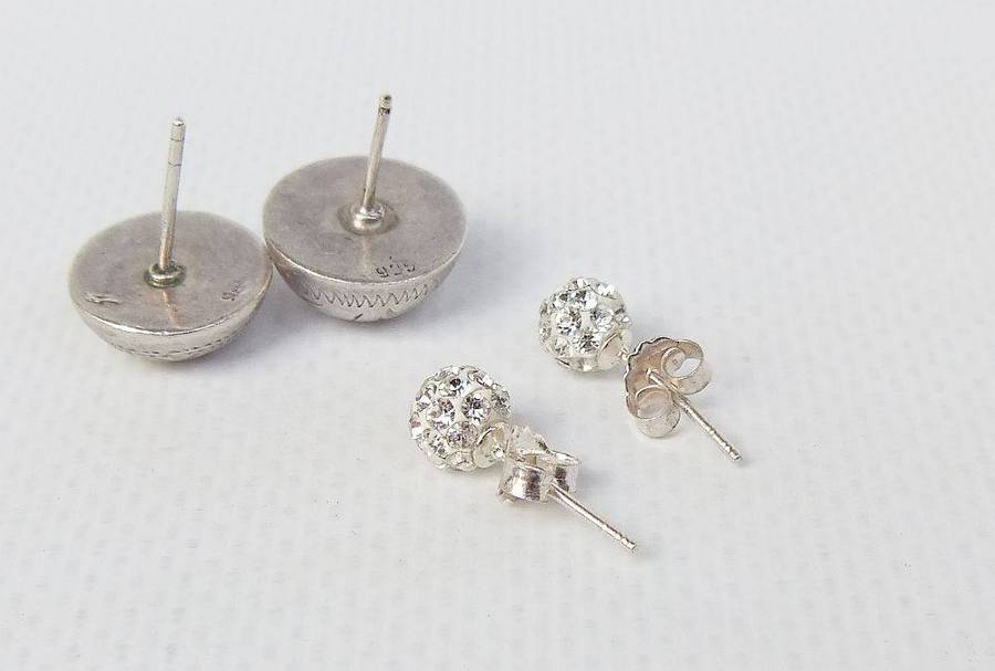A pair of sterling silver dome earrings and sterling silver studs with faceted insets