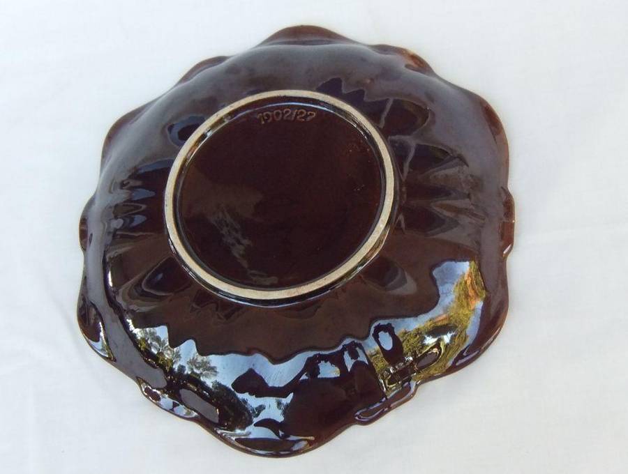 A vintage mid-century hand painted and numbered German pottery snack dish