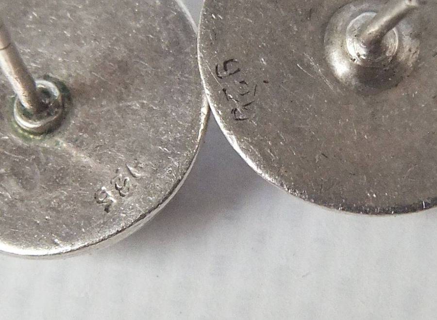 A pair of sterling silver dome earrings and sterling silver studs with faceted insets