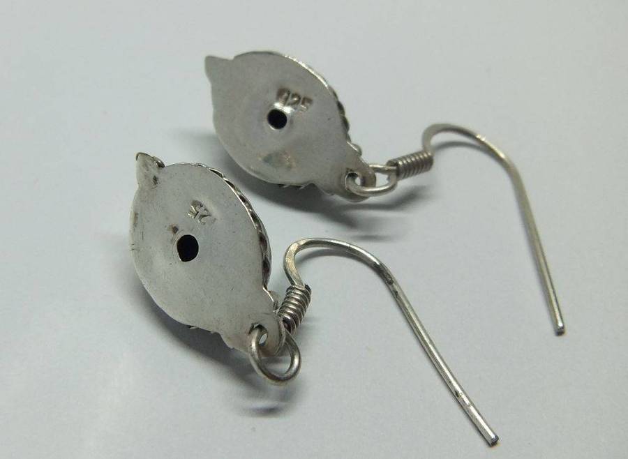 A pair of vintage sterling silver earrings set with cabochon Turquoise stones