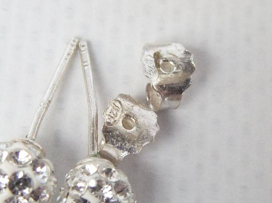 A pair of sterling silver dome earrings and sterling silver studs with faceted insets