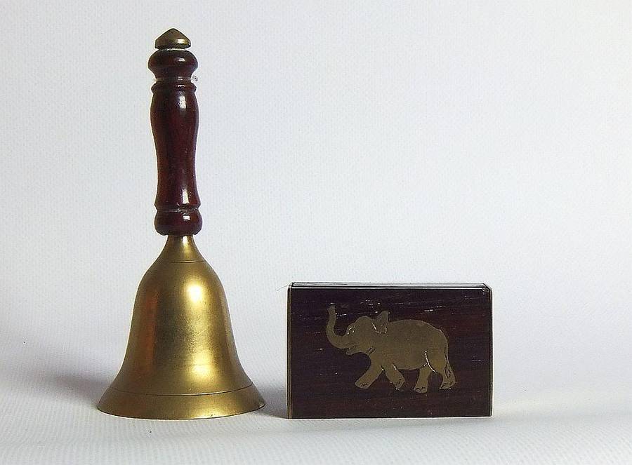 A vintage brass bell with wooden handle and wooden box with brass fittings and inlay
