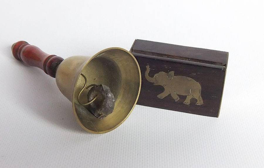A vintage brass bell with wooden handle and wooden box with brass fittings and inlay