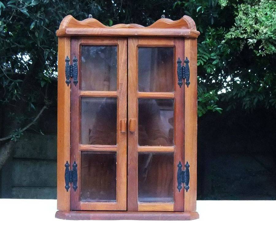 A stunning vintage wooden corner display cabinet with shelving for your collectables