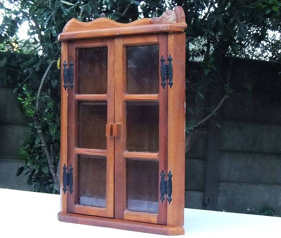 A stunning vintage wooden corner display cabinet with shelving for your collectables