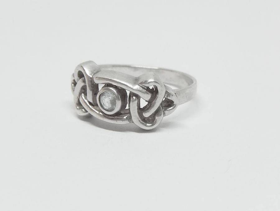 A stunning Celtic motif sterling silver ring set with a faceted pale blue stone