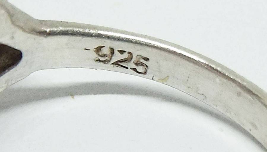 A stunning Celtic motif sterling silver ring set with a faceted pale blue stone