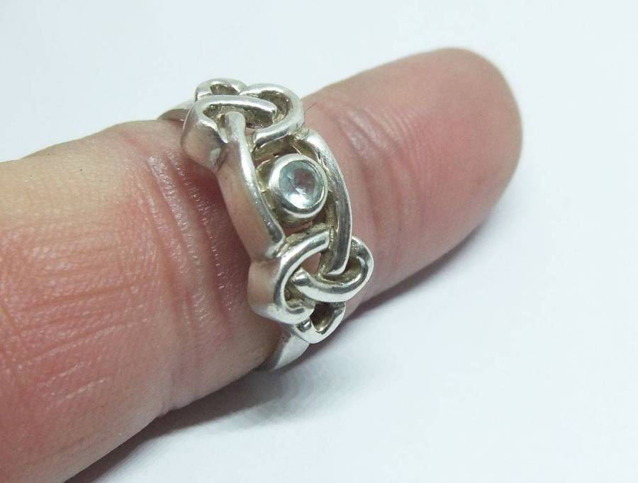 A stunning Celtic motif sterling silver ring set with a faceted pale blue stone