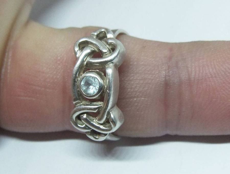 A stunning Celtic motif sterling silver ring set with a faceted pale blue stone