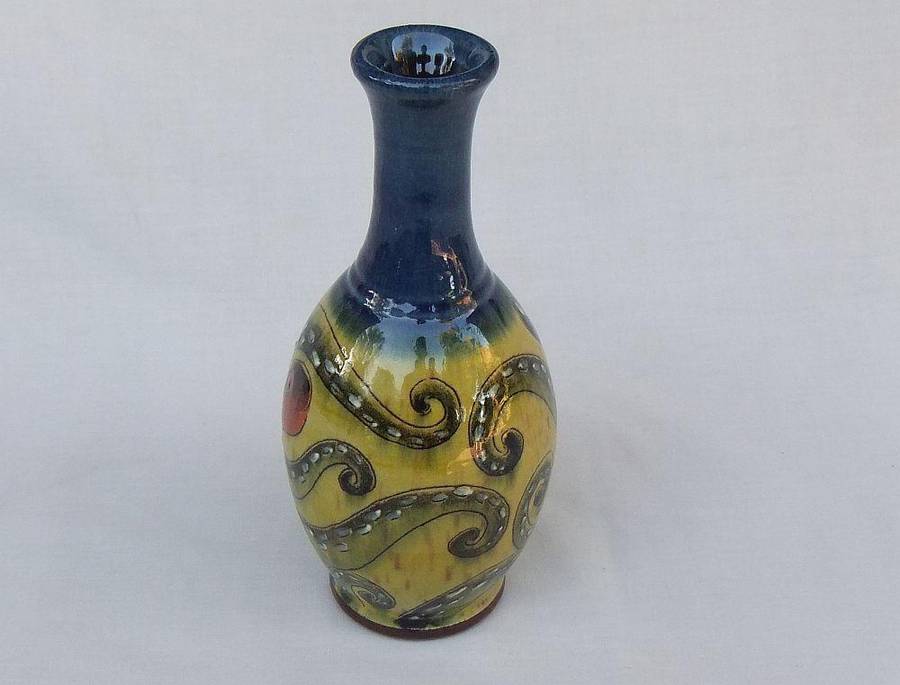A signed vintage handmade pottery vase with octopus motif