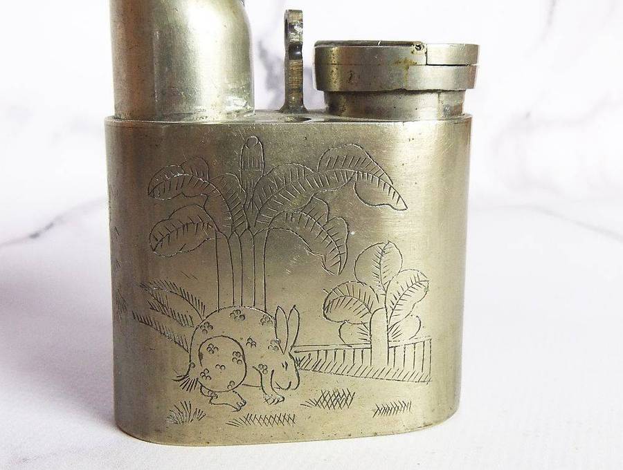 An antique Chinese opium pipe with engraved detail and makers marks for Hong Kong and Rui Xing Long