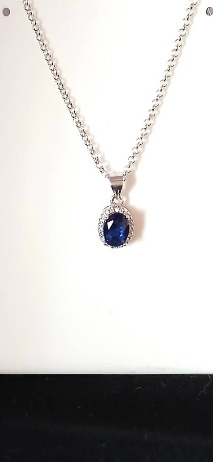 Sterling silver pendant with blue stone on chain