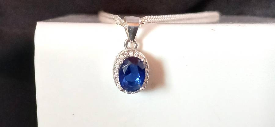 Sterling silver pendant with blue stone on chain