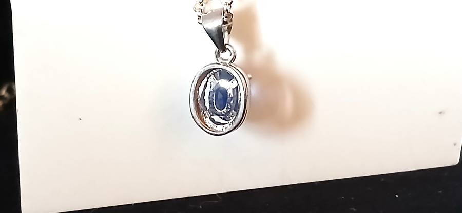 Sterling silver pendant with blue stone on chain