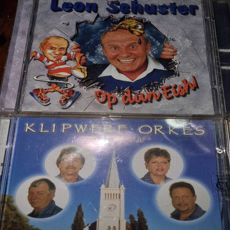 4 x Afrikaanse CD's - Leon Schuster, Klipwerf, Robbie Wessels & Piet Smit