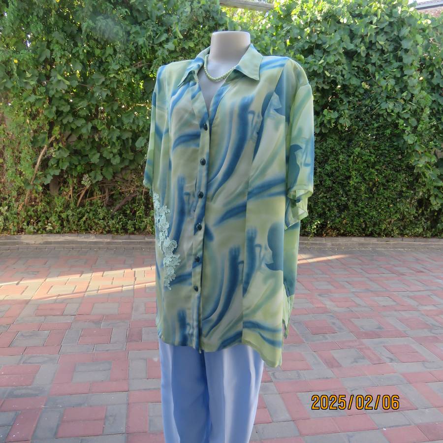 Boutique made silky polyester blue-green patterned size 50 styled top. Open collar.As new