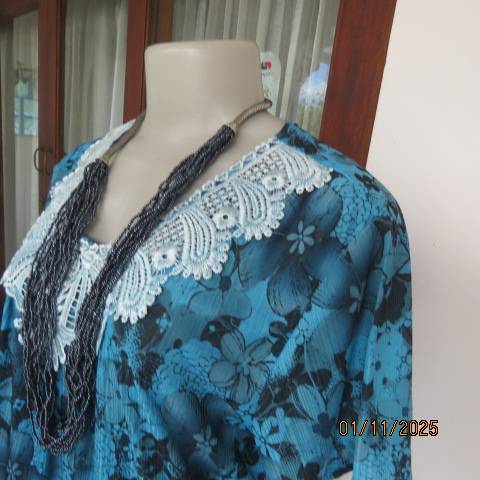 Turkish blue textured stretch polyester top with black floral print in size 38-40