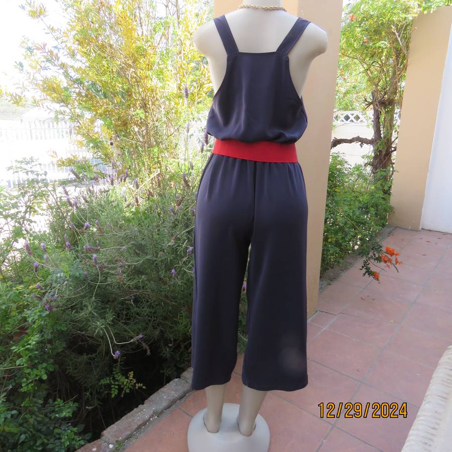 Boutique made dark navy polyester satin like pantsuit size 36. Shoulder straps. As new.