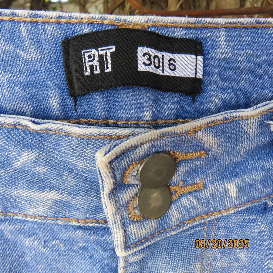 Blue denim distressed jean shorts size 30 with raw edge leg seams.
