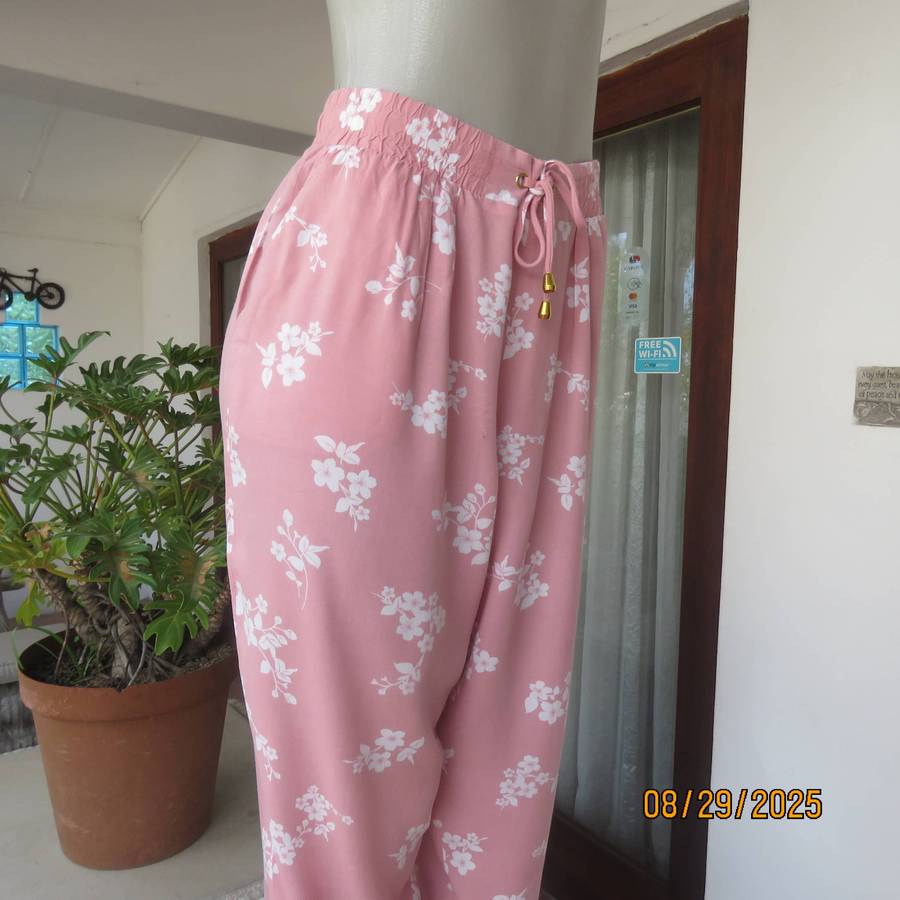Salmon pink viscose pants with white floral pants. Elasticated waist. Size 40
