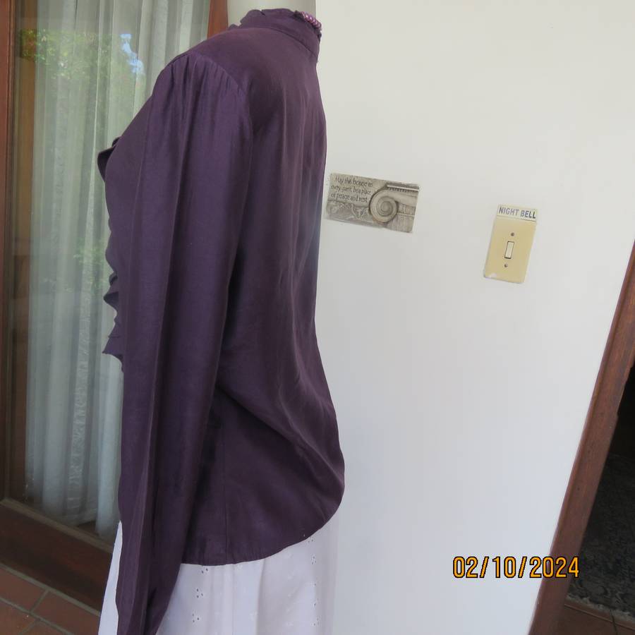Smart shiny dark purple long sleeve tailored top size 34. V front with banded neckline.As new cond.