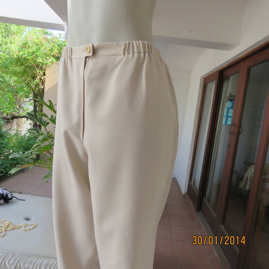 Boutique made mottled cream polyester pants.Tapered legs.Elasticated waist band.Size 40.As new