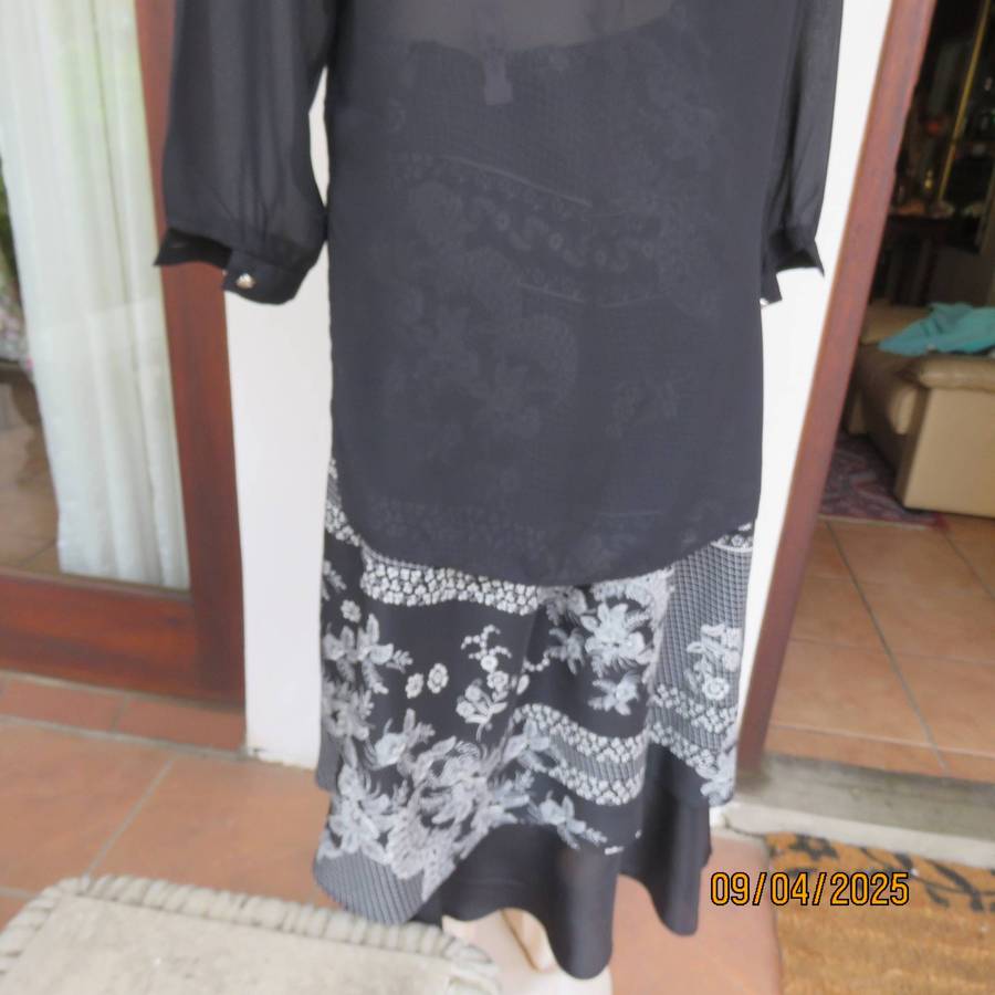 Very black long sleeve sheer top with embroidered front. Front halfway button down. Size 38-40