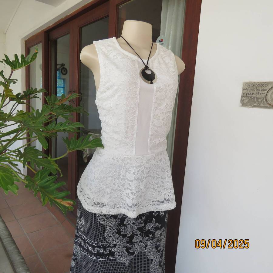 White stretch polyester lace slip over peplum top fully lined. Size 38