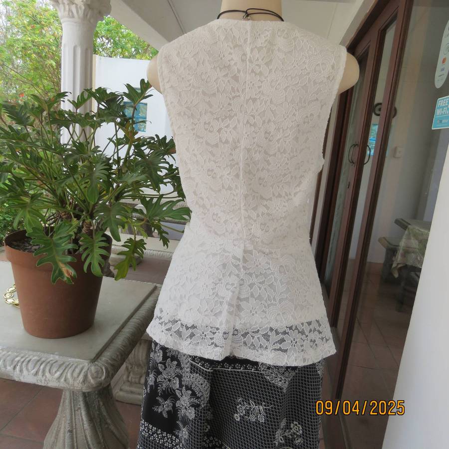 White stretch polyester lace slip over peplum top fully lined. Size 38