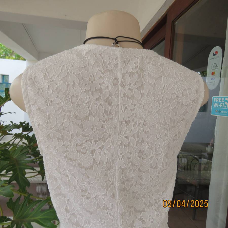 White stretch polyester lace slip over peplum top fully lined. Size 38