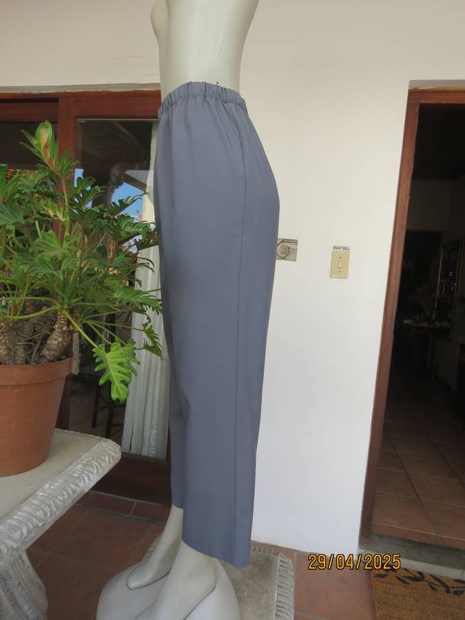 Boutique made hailstorm grey 100% polyester with elasticated waist. Size 40