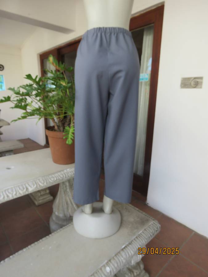 Boutique made hailstorm grey 100% polyester with elasticated waist. Size 40