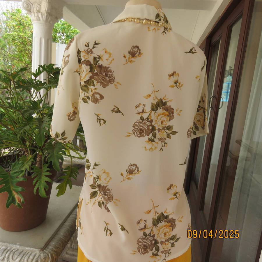 Cream button down polyester short sleeve top with yellow-green floral print. Size 34