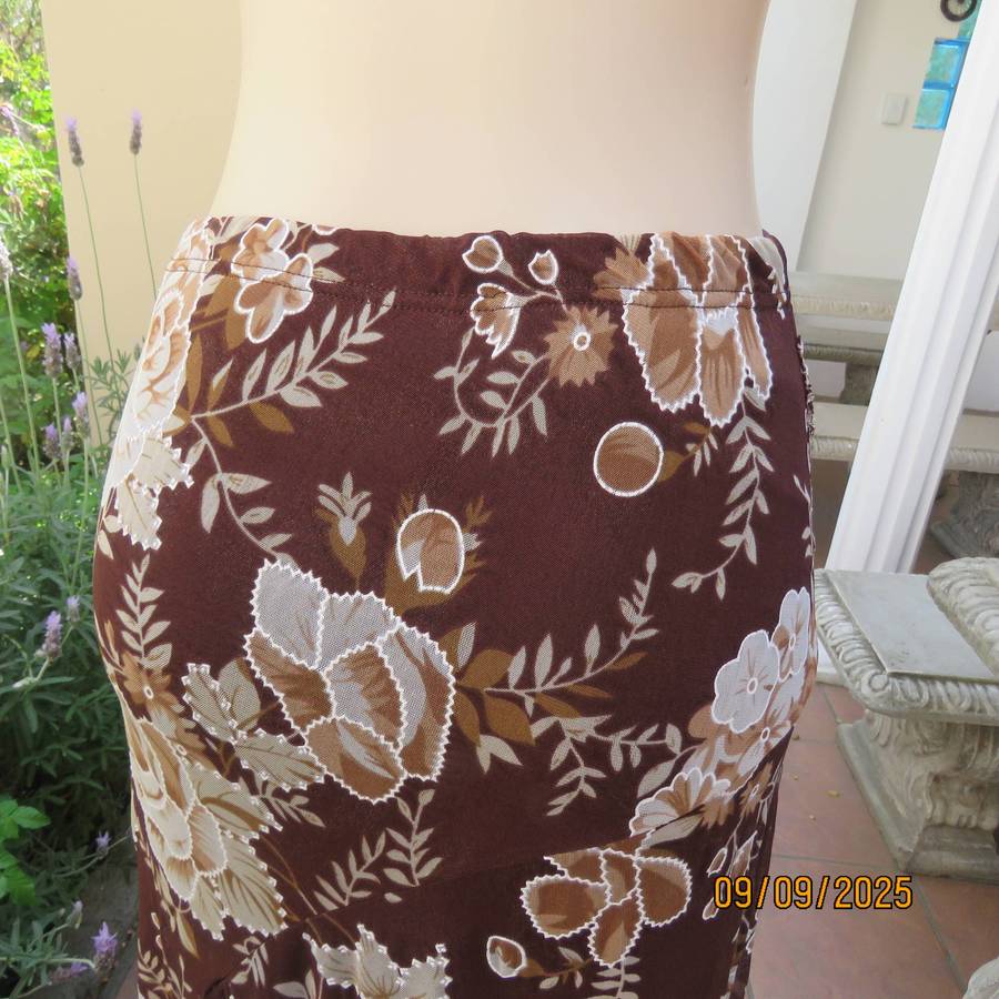 Brown with bold white-beige floral print sheer polyester skirt halfway lined. Size 38