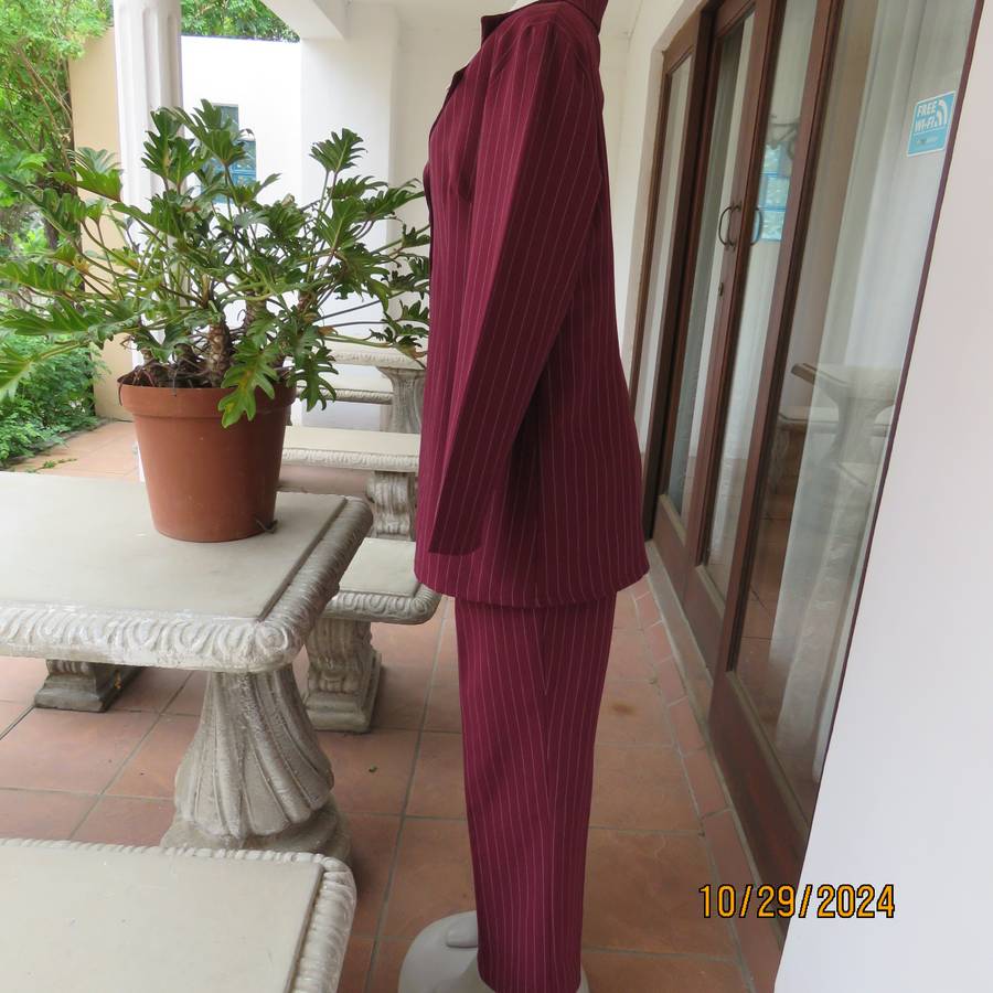 Classic maroon-white pinstripe 2 pc pantsuit. In 100% polyester. Tailored 1 button jacket. Size 40.