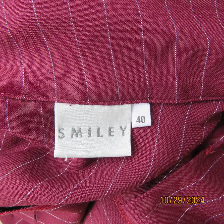 Classic maroon-white pinstripe 2 pc pantsuit. In 100% polyester. Tailored 1 button jacket. Size 40.