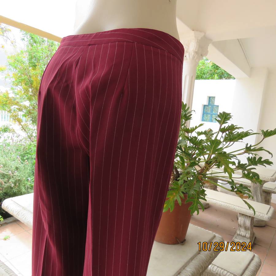 Classic maroon-white pinstripe 2 pc pantsuit. In 100% polyester. Tailored 1 button jacket. Size 40.