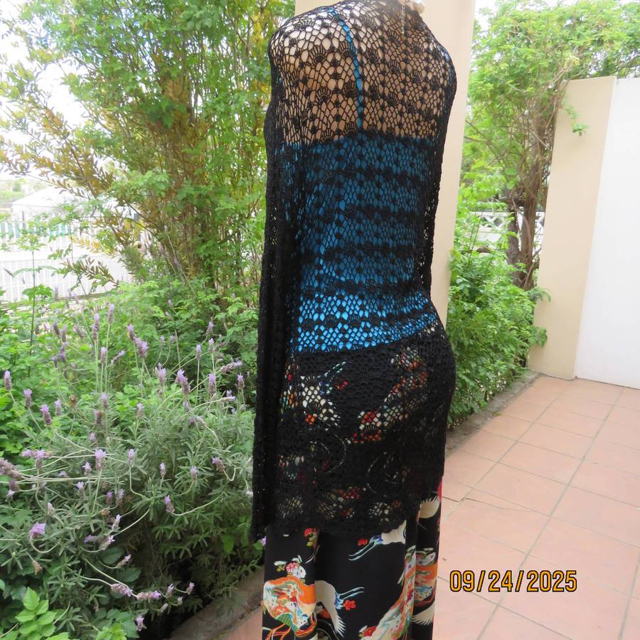 Black long sleeve poly-cotton crochet long cardigan. Four button closure. Size 34