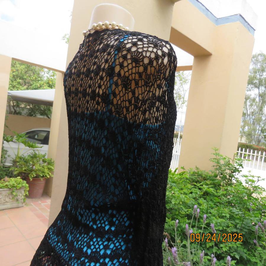 Black long sleeve poly-cotton crochet long cardigan. Four button closure. Size 34
