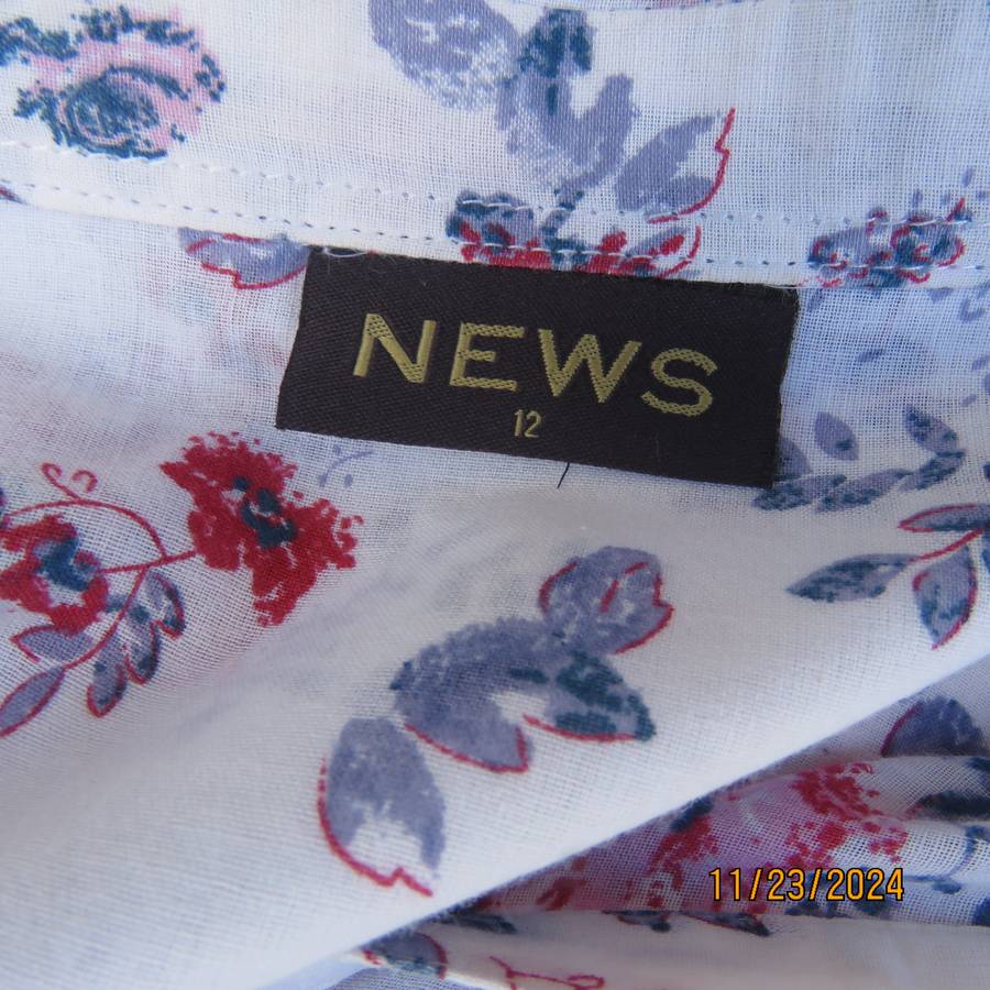 Charming tailored capped sleeve fine cotton white with red-blue floral posies. Size 36. Open collar.
