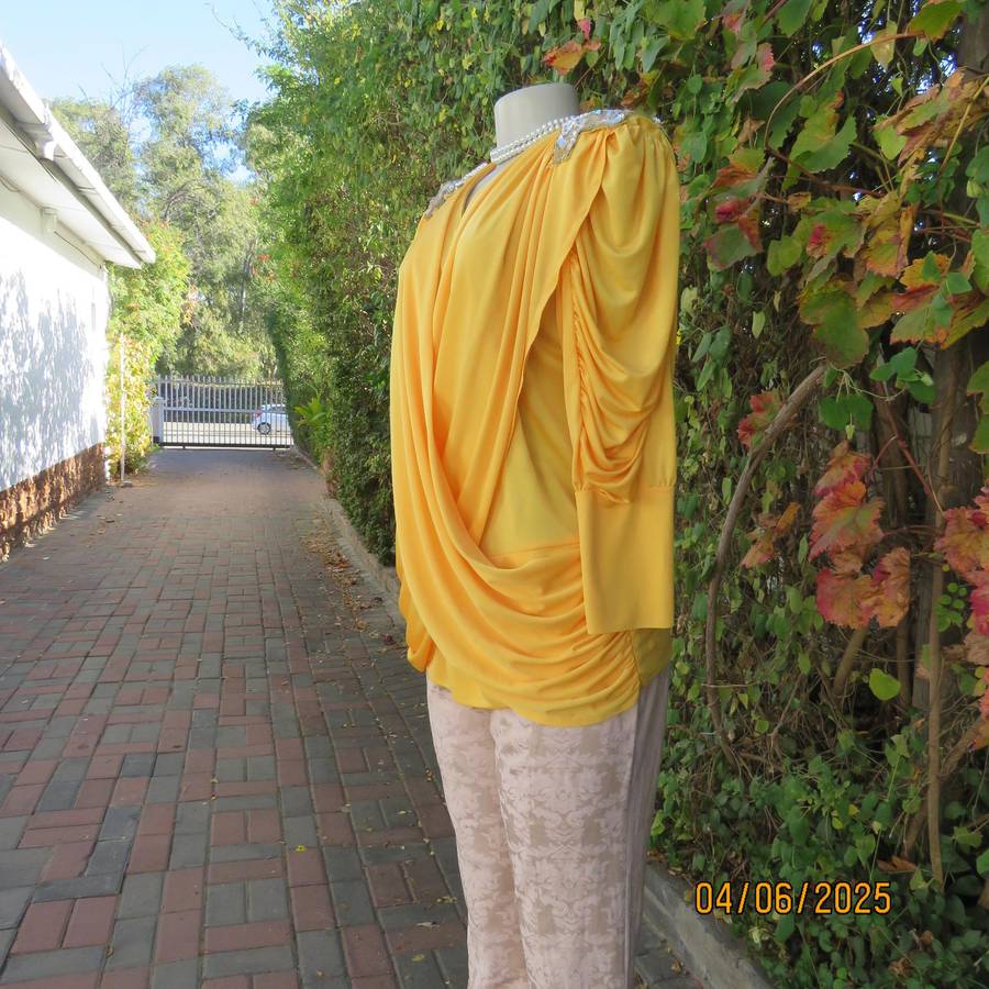 Buttercup yellow unique size 40 stretch polyester top. Crossover overlays. Shoulder decoration.