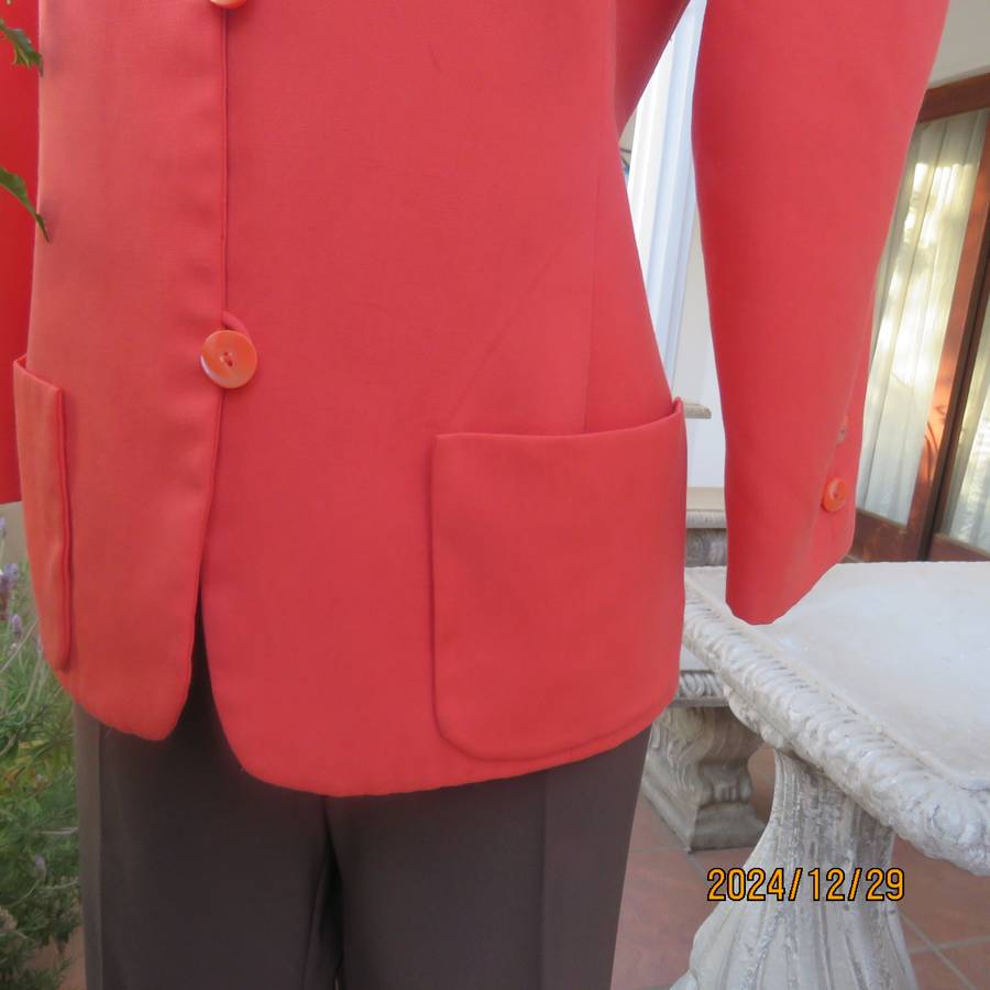Stunning boutique made papaya colour long sleeve lined collarless jacket.Size 38.Poly-viscose blend.