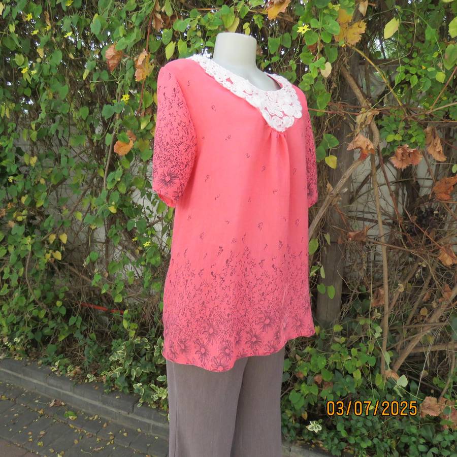Crimson slip over size 42 short sleeve top with dull black print. 100% Rayon.