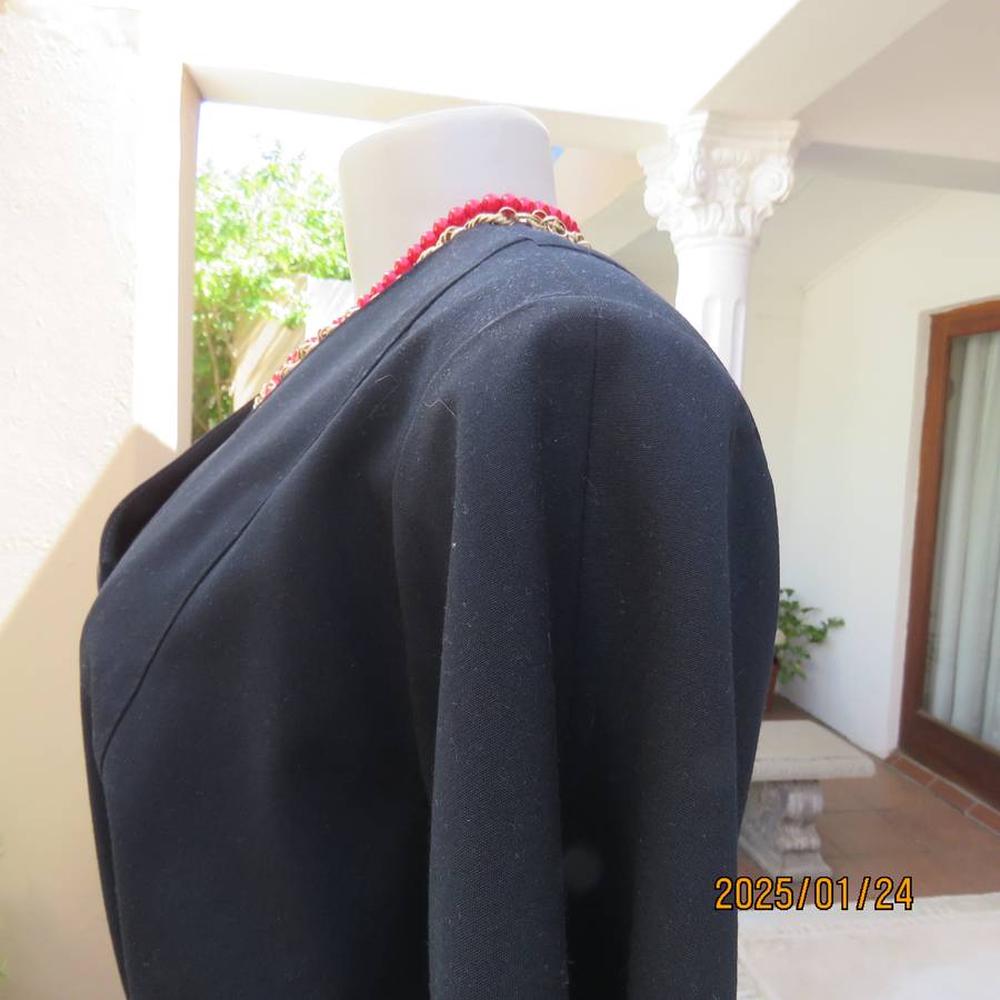 Elegant black short sleeve firm polycotton collarless jacket. Four button closure. Size 40. As new