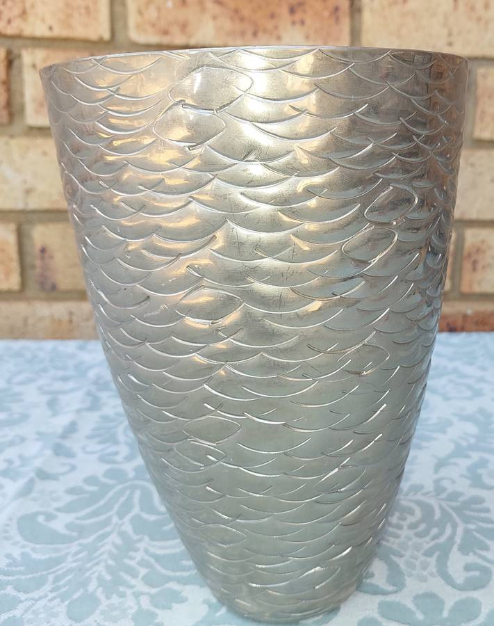 A FISH SCALE PATTERNED STEEL VASE