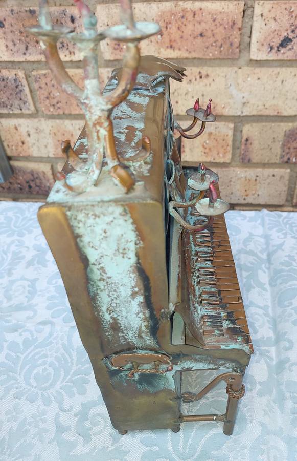 A COLLECTION OF COPPER FIGURINE ART SCULPTURES A PIANIST ,A PIANO WITH A SAXOPHONIST AND A BICYCLE