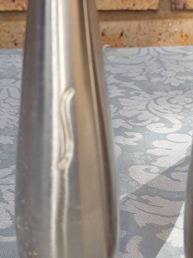 A PAIR OF STAINLESS STEEL SALT N PEPPER SHAKERS SOLD AS IS