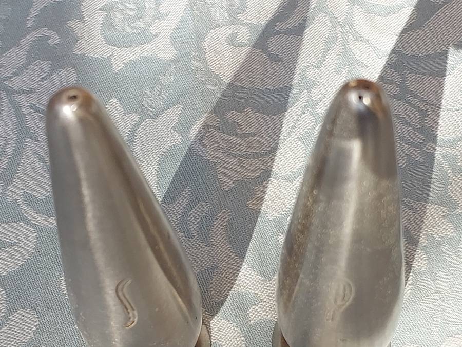 A PAIR OF STAINLESS STEEL SALT N PEPPER SHAKERS SOLD AS IS